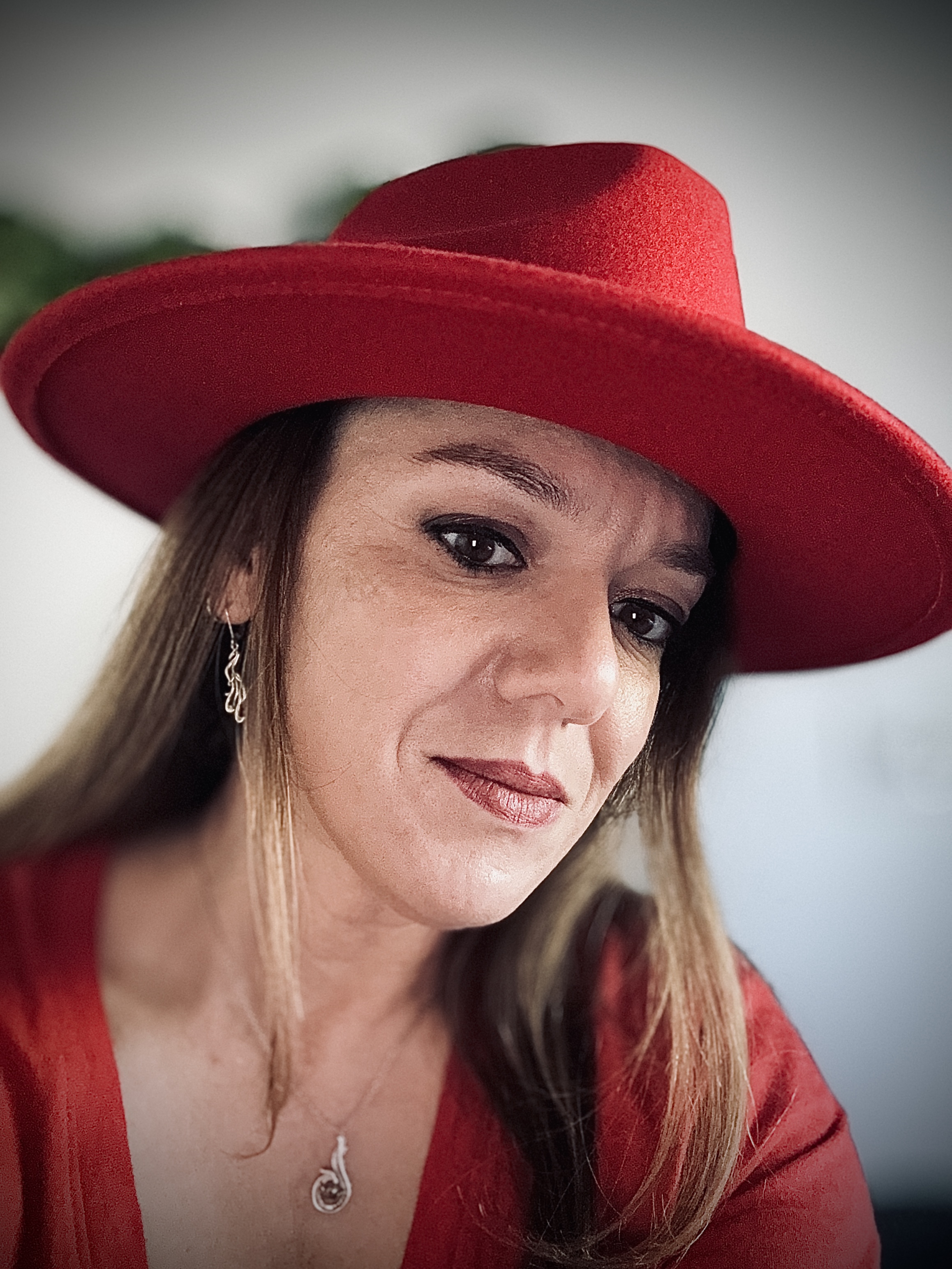 Nelia wearing her signature red hat